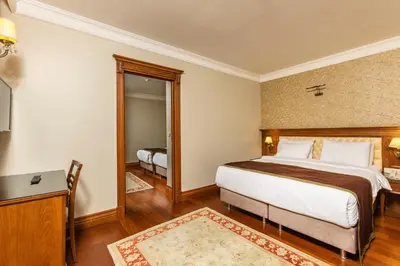 a hotel room with a large bed and a mirror at Acra Hotel - Special Category in Istanbul