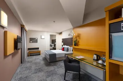 a hotel room with a bed and a desk at Nippon Hotel in Istanbul