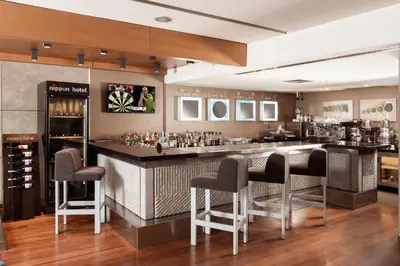 a bar in a restaurant with bar stools at Nippon Hotel in Istanbul