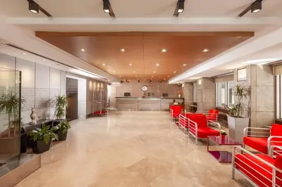 a lobby with red chairs and a waiting room at Nippon Hotel in Istanbul