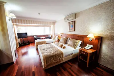 a hotel room with a bed with a teddy bear on it at Hotel Centrum Istanbul in Istanbul