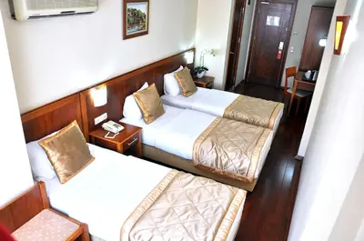 a hotel room with two beds and a table at Hotel Centrum Istanbul in Istanbul