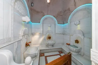 a white bathroom with two toilets and a sink at Wyndham Istanbul Old City in Istanbul