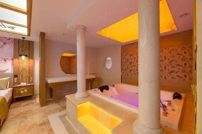 a bathroom with a tub with columns and a sink at Wyndham Istanbul Old City in Istanbul