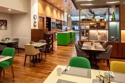 a restaurant with tables and chairs and a bar at Holiday Inn Sisli by IHG in Istanbul
