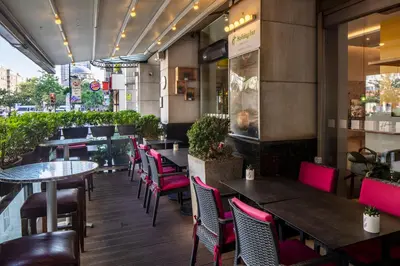 a restaurant with pink chairs and tables and tables at Holiday Inn Sisli by IHG in Istanbul