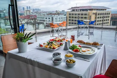 a table with plates of food on top of a building at Point Hotel Taksim in Istanbul