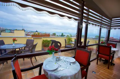 a dining room with tables and chairs and a balcony at Amber Hotel & Spa in Istanbul