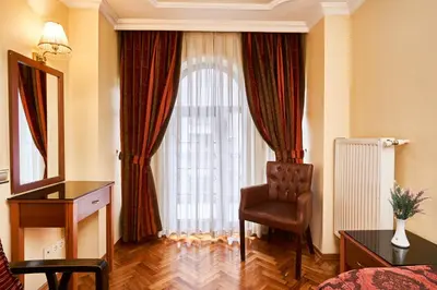 a living room with a chair and a large window at Amber Hotel & Spa in Istanbul