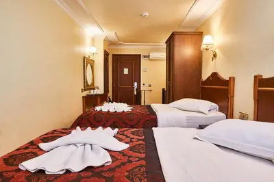 a hotel room with two beds with white towels on them at Amber Hotel & Spa in Istanbul