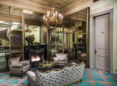 a living room with a fireplace and a couch and a chandelier at Bosphorus Palace Hotel in Istanbul