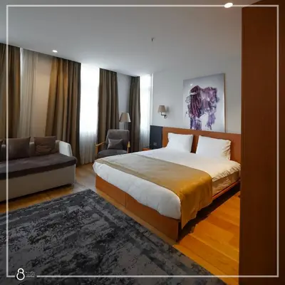 a hotel room with a bed and a couch at Misafir Suites 8 Istanbul in Istanbul