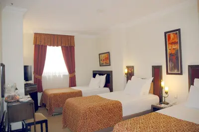 a hotel room with two beds and a window at Güneş Hotel Merter in Istanbul