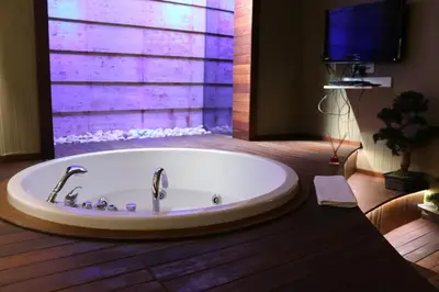 a large bath tub in a bathroom with a tv at Triada Hotel Taksim - Special Category in Istanbul