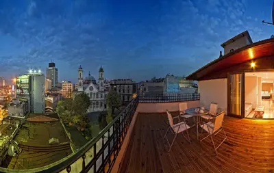 a balcony with a table and chairs and a city skyline at Triada Hotel Taksim - Special Category in Istanbul