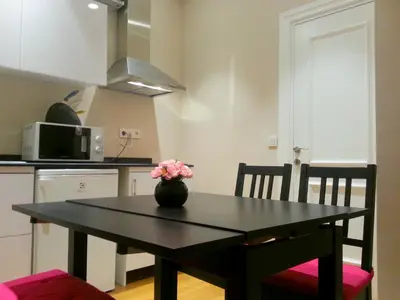 a table with a vase of flowers on it in a kitchen at Triada Hotel Taksim - Special Category in Istanbul