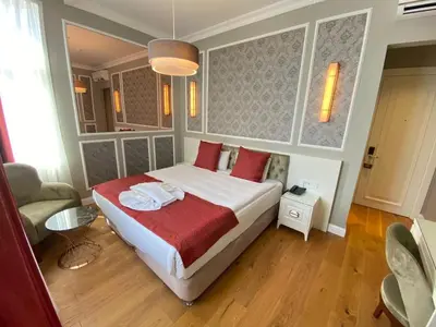 a bedroom with a large bed with red pillows at Triada Hotel Taksim - Special Category in Istanbul