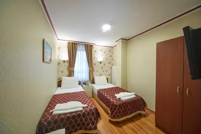 a hotel room with two beds and a window at Hotel Akcinar in Istanbul