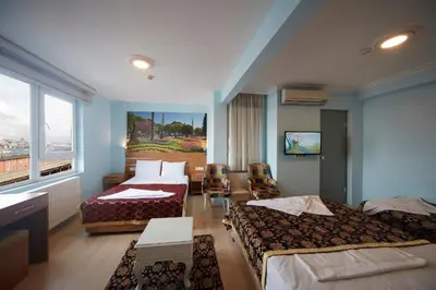 a hotel room with two beds and a window at Hotel Akcinar in Istanbul