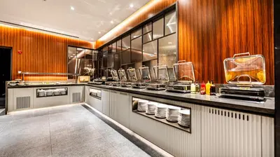 a restaurant kitchen with a counter with dishes at Lamartine Hotel in Istanbul