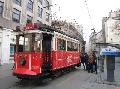 a red trolley car parked on a city street at Lamartine Hotel in Istanbul