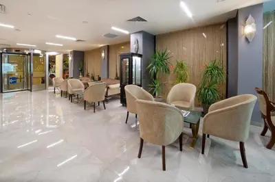a waiting room with chairs and tables in a lobby at Hotel Bulvar Palas in Istanbul