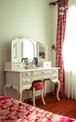 a white dressing table with a mirror and a chair at Sphendon Hotel in Istanbul