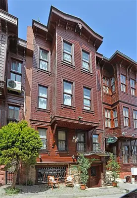 a large wooden building with windows on a street at Sphendon Hotel in Istanbul