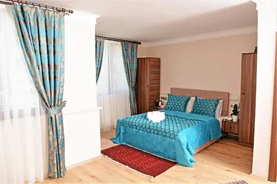 a bedroom with a blue bed and a window at Sphendon Hotel in Istanbul