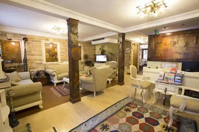 a living room filled with furniture and a tv at Sphendon Hotel in Istanbul