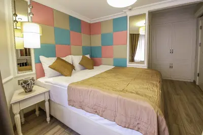 a bedroom with a bed and a colorful wall at The Constantine Hotel in Istanbul
