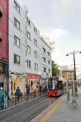 a red and white tram on a city street at The Constantine Hotel in Istanbul