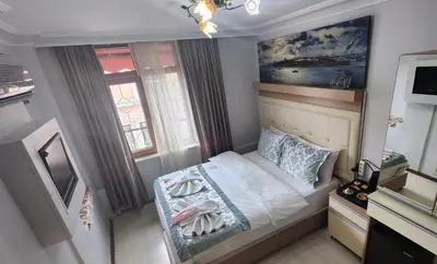 a small bedroom with a bed and a window at Oceans 7 Hotel in Istanbul