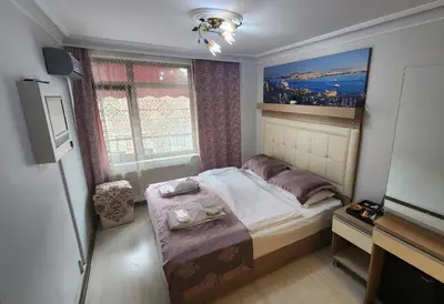 a small bedroom with a bed and a window at Oceans 7 Hotel in Istanbul