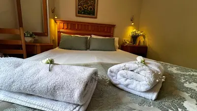 a bedroom with a bed with towels on it at Park Star Hotel Taksim in Istanbul