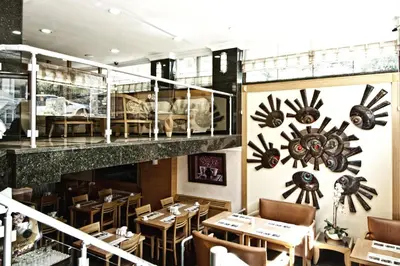 a restaurant with tables and chairs and a staircase at Park Star Hotel Taksim in Istanbul