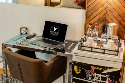 a desk with a laptop computer on top of it at Parkhouse Hotel & Spa in Istanbul