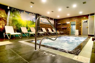 a jacuzzi tub in a room with chairs at Parkhouse Hotel & Spa in Istanbul