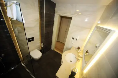 a bathroom with a toilet and a sink and a shower at Bilek Istanbul Hotel in Istanbul