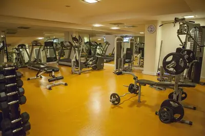 a gym with a bunch of equipment in a room at Bilek Istanbul Hotel in Istanbul