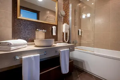 a bathroom with a sink and a bath tub and a sink at Mangana Konak Hotel in Istanbul
