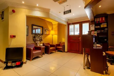 a waiting room with chairs and a tv at Mangana Konak Hotel in Istanbul