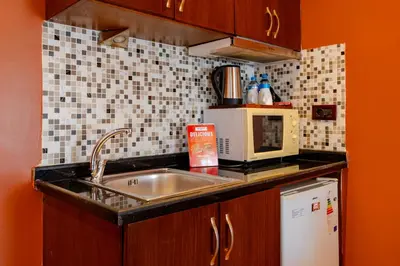 a kitchen with a sink and a microwave at Mangana Konak Hotel in Istanbul
