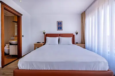 a bedroom with a large bed and a window at Mangana Konak Hotel in Istanbul