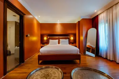 a hotel room with a bed and a bathroom at Mangana Konak Hotel in Istanbul
