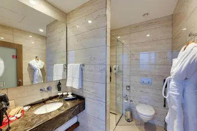 a bathroom with a sink and a toilet and a mirror at Ramada by Wyndham Istanbul Old City in Istanbul