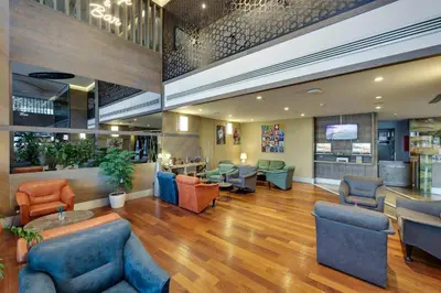 a lobby of a hospital with chairs and tables at Ramada by Wyndham Istanbul Old City in Istanbul