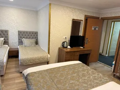 a hotel room with two beds and a flat screen tv at Angels Garden Hotel - Special Catagory in Istanbul