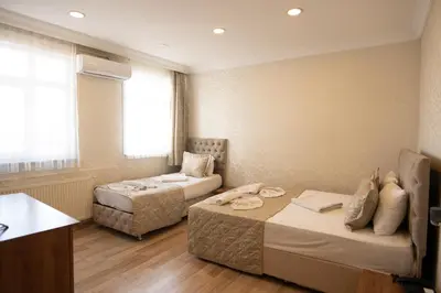 a hotel room with two beds and a couch at Angels Garden Hotel - Special Catagory in Istanbul