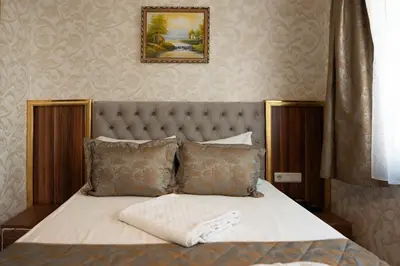 a bedroom with a bed with a white blanket on it at Angels Garden Hotel - Special Catagory in Istanbul